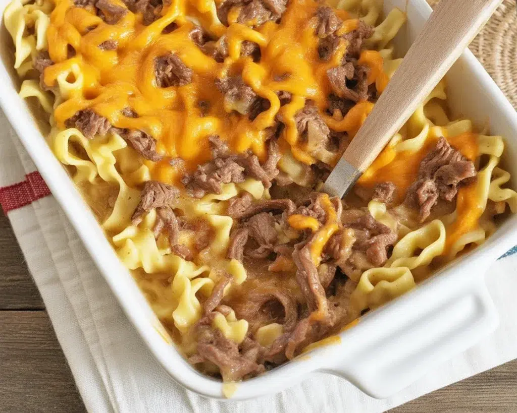 Delicious Sour Cream Beef Noodle Casserole with layers of cheese and savory beef.
