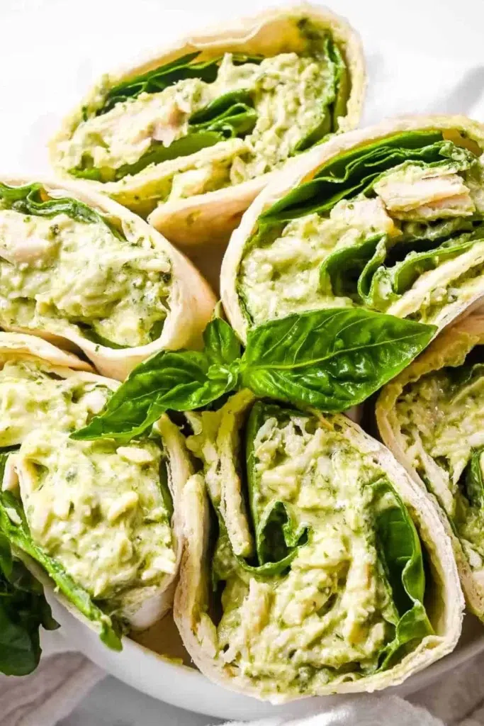 Delicious Pesto Chicken Salad with shredded chicken, fresh vegetables, and creamy dressing.