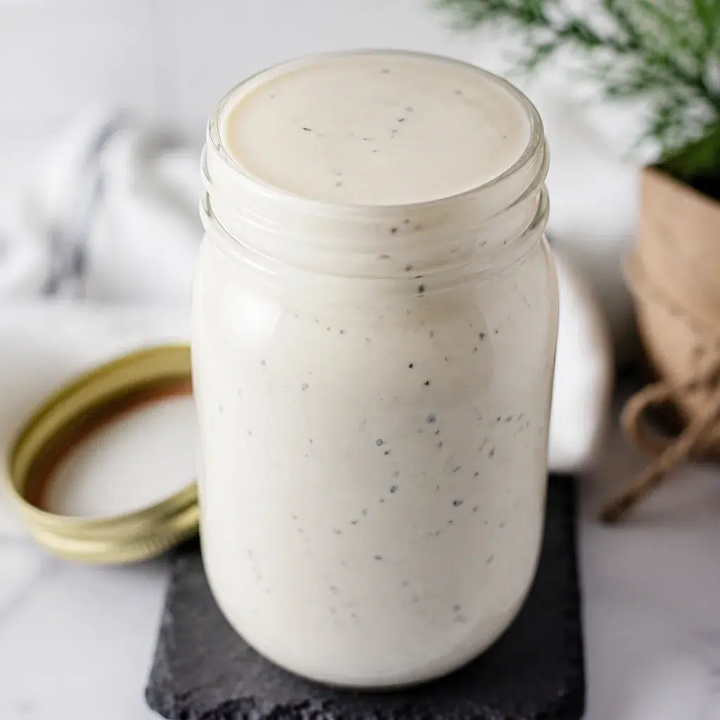 A bowl of creamy Alabama White Sauce, perfect for BBQ dishes.